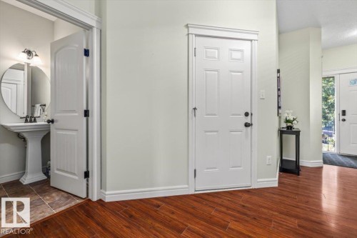 Hardwood-finish flooring, white paneled doors, and light wall finishes - 11506 17 Avenue Sw, Edmonton, AB 