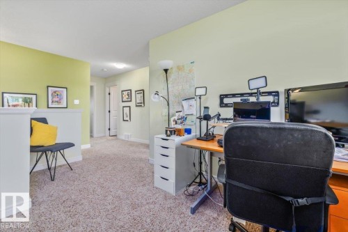Carpet flooring, light green wall finishes, white trim, and a built-in half-wall railing - 11506 17 Avenue Sw, Edmonton, AB 