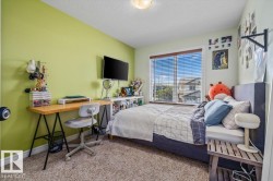 Recessed lighting, wood-finish window blinds, and light-colored carpeting - 