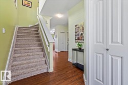 Staircase with carpeted treads and white wood-finish railing - 