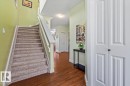 Staircase with carpeted treads and white wood-finish railing - 11506 17 Avenue Sw, Edmonton, AB 