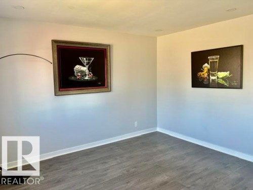 Recessed ceiling lighting, light-toned walls, wood-finish flooring, and white baseboards - 5614 50 Street, Vegreville, AB 