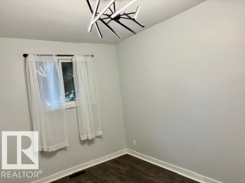 White walls with wood-finish flooring - 5614 50 Street, Vegreville, AB 