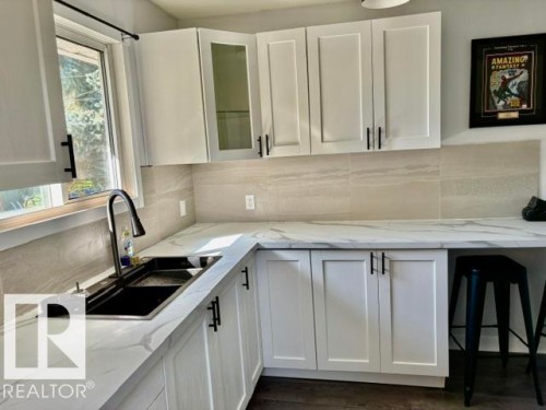 White shaker-style cabinetry with matte black hardware - 5614 50 Street, Vegreville, AB 