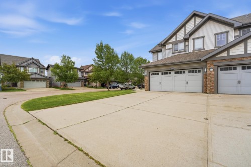 Attached two-car garage, single garage, concrete driveway, and stone facade accents - 20007 131 Avenue Nw, Edmonton, AB 