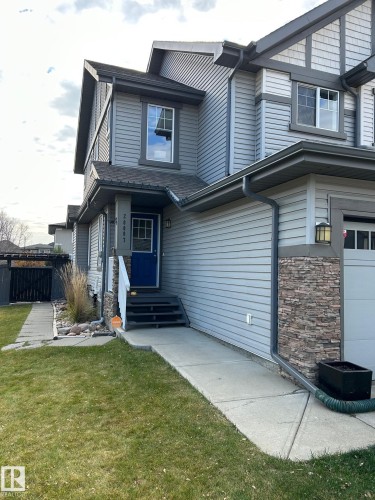 Multi-level dwelling with shingle roofing, horizontal siding, and stone veneer accents - 20007 131 Avenue Nw, Edmonton, AB 