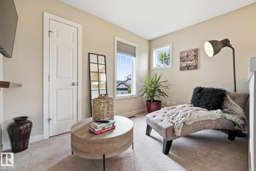 Warm neutral wall color, plush carpet flooring, multiple windows, and a built-in wall shelf - 20007 131 Avenue Nw, Edmonton, AB 