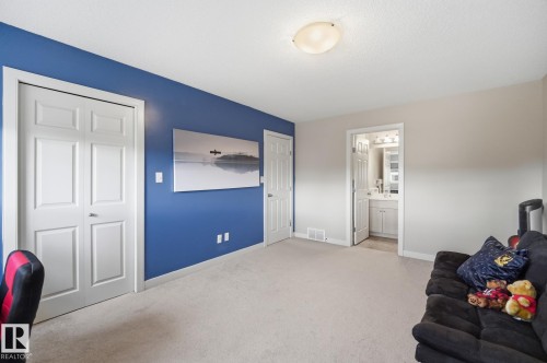 Plush carpet flooring, recessed closet with bifold doors, and a ceiling-mounted light fixture - 20007 131 Avenue Nw, Edmonton, AB 