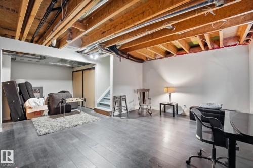 Spacious lower level featuring wood-finish flooring, recessed lighting, and a built-in closet with sliding doors - 20007 131 Avenue Nw, Edmonton, AB 