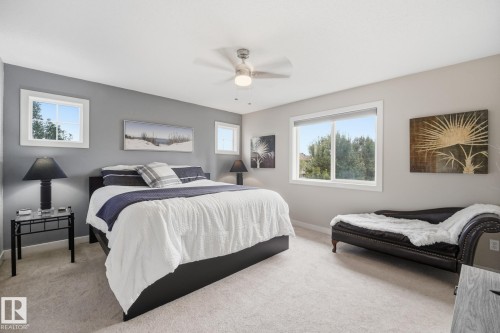 Expansive room featuring carpeted flooring, a ceiling fan, and multiple windows providing natural light - 20007 131 Avenue Nw, Edmonton, AB 