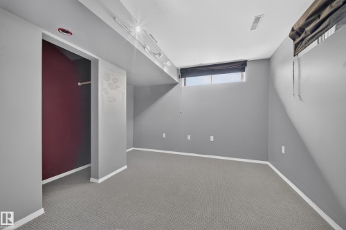 Carpeted flooring, recessed lighting, track lighting, and a window with blinds - 155 Marlborough Place Nw, Edmonton, AB 