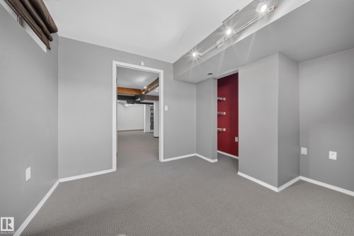 Grey carpet flooring, track lighting, neutral wall tones, and recessed shelving - 155 Marlborough Place Nw, Edmonton, AB 