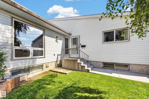 White horizontal siding exterior with a prominent picture window - 155 Marlborough Place Nw, Edmonton, AB 