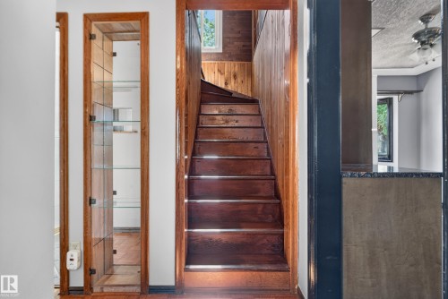 Wood staircase with wood-paneled walls - 13351 109A Avenue Nw, Edmonton, AB 