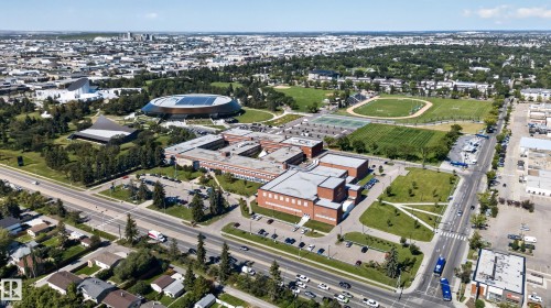 Expansive neighborhood featuring a large university campus, multiple athletic fields, tennis courts, and mature trees throughout - 13351 109A Avenue Nw, Edmonton, AB 