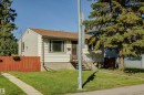 Single-story exterior with light-colored siding and stucco, featuring a brown shingle roof - 10916 151 Street Nw, Edmonton, AB 