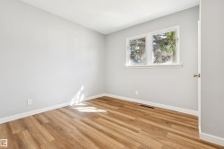 Wood-finish flooring, white trim, and light gray walls - 