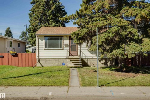 Single-story residence featuring light-colored siding and a brown shingled roof - 10916 151 Street Nw, Edmonton, AB 