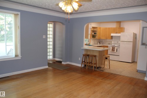 Wood-finish flooring throughout the main living space - 4406 49A Street, Vegreville, AB 