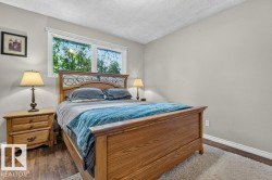 Bedroom featuring wood-finish flooring, a double window, and light gray painted walls - 