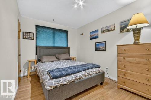 Bedroom featuring wood-finish flooring, a window with blinds, and recessed lighting - 11131 35A Avenue Nw, Edmonton, AB - Indoor Photo Showing Bedroom
