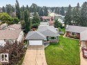 Single-story residence featuring a gray shingle roof and green siding - 11131 35A Avenue Nw, Edmonton, AB  - Outdoor 
