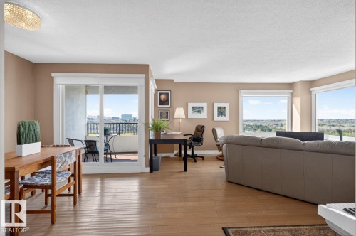 Spacious living area featuring hardwood flooring & expansive windows. West & South Facing Views; - #602 12303 Jasper Av Nw, Edmonton, AB 