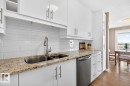 What if you have armloads of groceries?  No Problem. This cleverly designed galley kitchen with convenient pass-through has 2 pullout pantry cupboards and space galore for all your dishes and appliances. - #602 12303 Jasper Av Nw, Edmonton, AB 