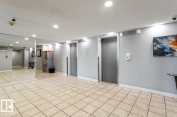 Building lobby featuring twin elevators. - 