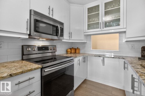 What if you have armloads of groceries?  No Problem. This cleverly designed galley kitchen with convenient pass-through has 2 pullout pantry cupboards and space galore for all your dishes and appliances. - #602 12303 Jasper Av Nw, Edmonton, AB 