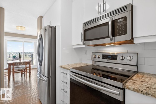What if you have armloads of groceries?  No Problem. This cleverly designed galley kitchen with convenient pass-through has 2 pullout pantry cupboards and space galore for all your dishes and appliances. - #602 12303 Jasper Av Nw, Edmonton, AB 