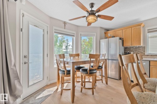 Wood-finish flooring, recessed lighting, and a five-blade ceiling fan with integrated lighting - 591 Byrne Crescent Sw, Edmonton, AB 