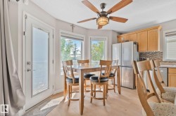 Wood-finish flooring, recessed lighting, and a five-blade ceiling fan with integrated lighting - 