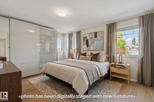 Wood-finish flooring with a flush-mount ceiling light - 591 Byrne Crescent Sw, Edmonton, AB 
