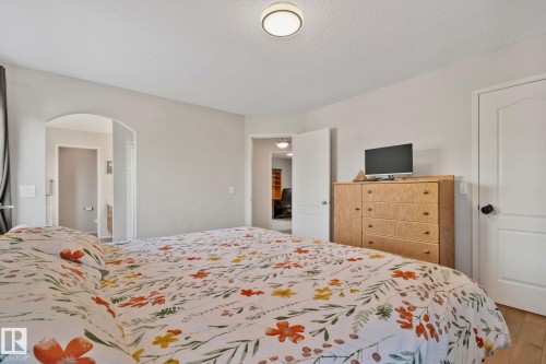 Light-toned walls with an arched doorway and solid core doors - 591 Byrne Crescent Sw, Edmonton, AB 