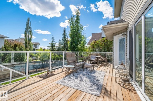 Expansive wood deck with glass panel railing - 591 Byrne Crescent Sw, Edmonton, AB 