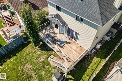 Expansive wood-finish deck with glass panel railing - 591 Byrne Crescent Sw, Edmonton, AB 