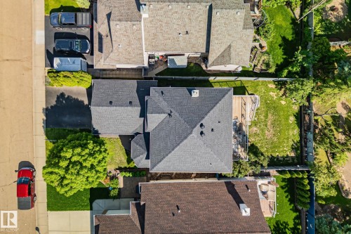 Property featuring a gabled roofline, expansive backyard, and a detached structure - 591 Byrne Crescent Sw, Edmonton, AB 