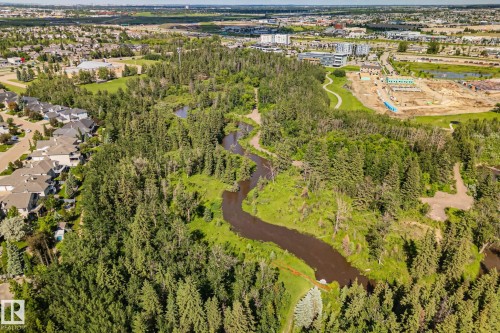 Expansive natural landscape featuring a winding river, dense evergreen and deciduous trees, and walking paths - 591 Byrne Crescent Sw, Edmonton, AB 