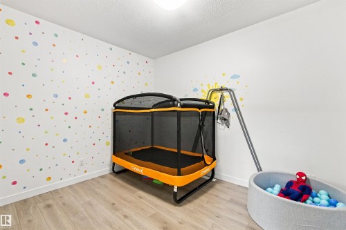 Wood-finish flooring with white baseboards and white walls - 107 Ellice Bend, Fort Saskatchewan, AB 