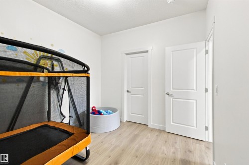 Neutral wall color, wood-finish flooring, and white interior doors - 107 Ellice Bend, Fort Saskatchewan, AB 