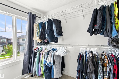 White wire shelving system, multiple hanging rods, and an operable window - 107 Ellice Bend, Fort Saskatchewan, AB 