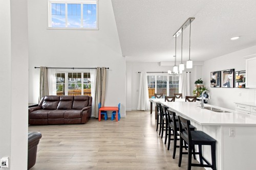 Vaulted ceilings, large transom window, wood-finish flooring, recessed lighting, and a kitchen island with seating - 107 Ellice Bend, Fort Saskatchewan, AB 