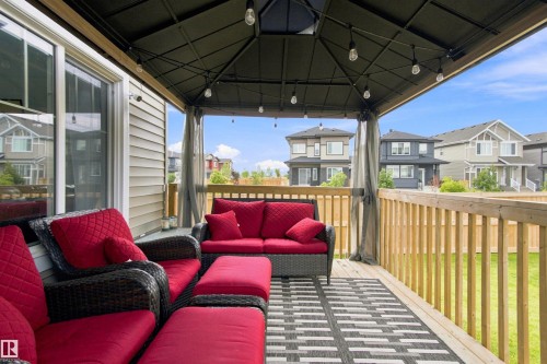 Covered patio featuring a gazebo, string lighting, and wood decking - 107 Ellice Bend, Fort Saskatchewan, AB 