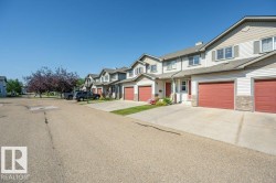 Exterior featuring siding, stone accents, attached garages, and concrete driveways - 
