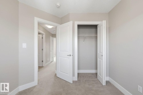 Bedroom featuring light gray wall paint, white trim, and neutral carpeting - 206 Southfork Drive, Leduc, AB - Indoor Photo Showing Other Room