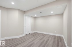 Spacious room featuring wood-finish flooring, recessed lighting, and a neutral color palette - 