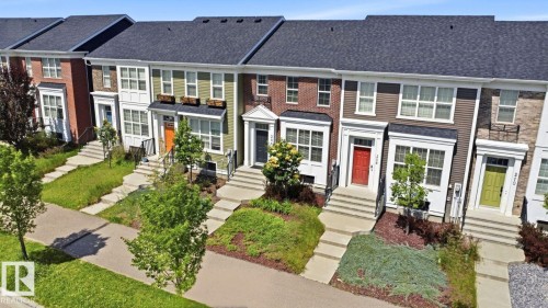 Row of townhomes featuring varied exterior finishes including brick and horizontal siding - 206 Southfork Drive, Leduc, AB - Outdoor With Facade