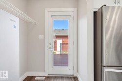 Full-lite exterior door with integrated blinds opening onto an outdoor deck - 