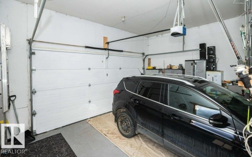 Attached garage with automatic overhead door opener and concrete flooring - 11007 108 Avenue, Westlock, AB 